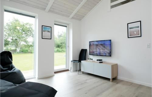a white living room with a desk and a tv at Stunning Home In Hjørring With Wifi in Hjørring