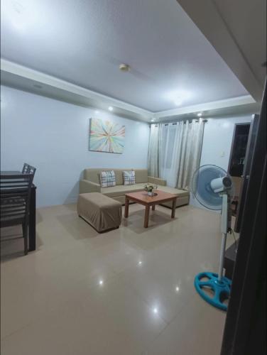 a living room with a couch and a table at Alles One Oasis Condo Davao Near SM Mall with Wifi in Davao City