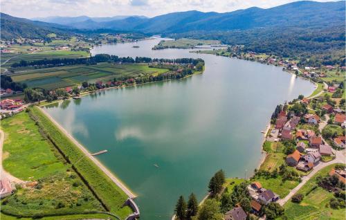 an aerial view of a river with houses and a town at Two-Bedroom Apartment In Ogulin in Jasenak
