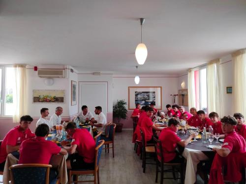 a group of people sitting at tables in a restaurant at Hotel Sporting in Casarsa della Delizia