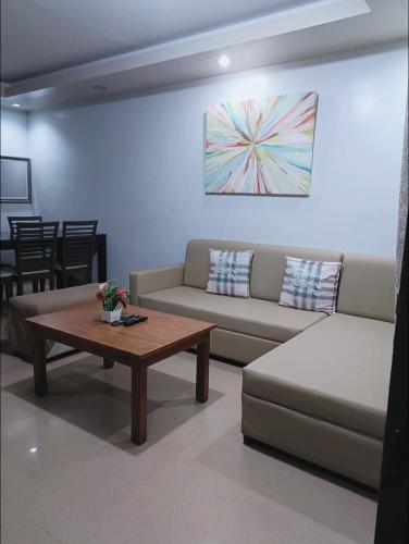 a living room with a couch and a coffee table at Davao 2br One Oasis Beside SM Mall-Wifi in Davao City