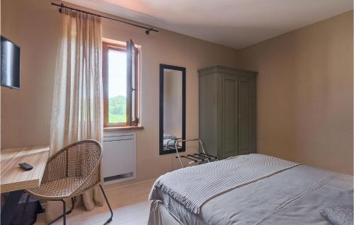 a bedroom with a bed and a desk and a window at Villa Brih Iii in Motovun