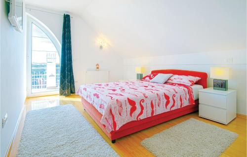 a white bedroom with a red bed and a window at Cozy Home In Varazdinske Toplice in Varaždinske Toplice