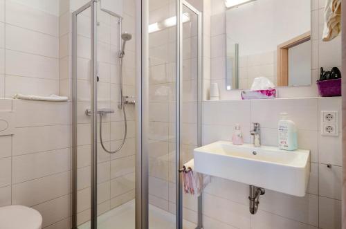 a bathroom with a shower and a sink at Pension Zum Talhof in Reichenau