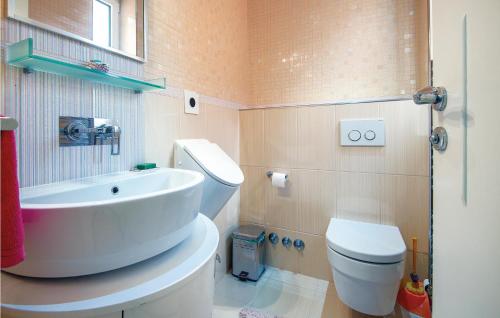 a bathroom with a white sink and a toilet at Cozy Home In Varazdinske Toplice in Varaždinske Toplice