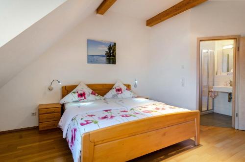 a bedroom with a bed with flowers on it at Pension Zum Talhof in Reichenau