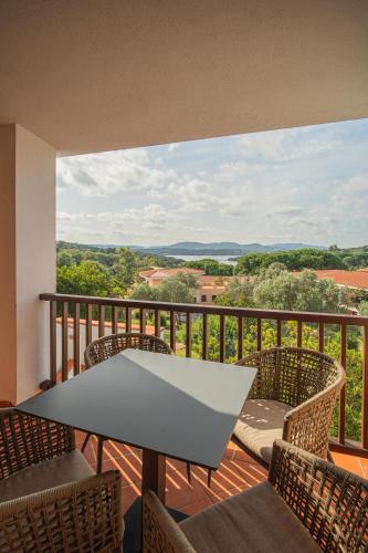 a balcony with chairs and a table with a view at Felix Hotels - Residence Hotel Costa Serena in Palau