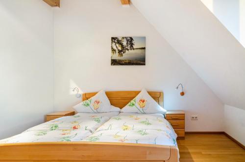 a bedroom with a bed in a attic at Pension Zum Talhof in Reichenau
