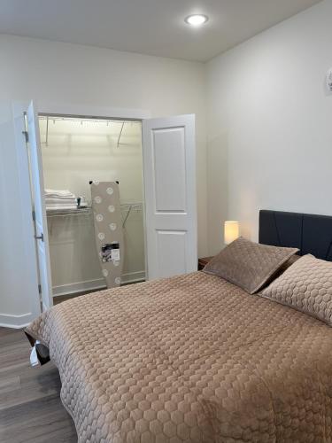 a bedroom with a large bed and a mirror at Church Hill Apt - TH02 - Tourist Homes of Richmond in Richmond