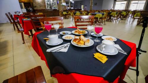 una mesa con platos de comida y copas de vino en Intersur Independencia, en Termas de Río Hondo