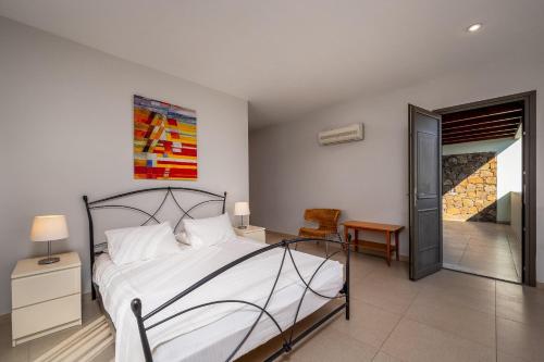 a bedroom with a bed and a room with a hallway at Gonos Villas in Asklipiḯon