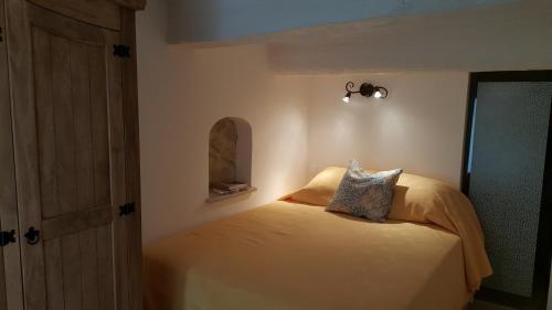 a bedroom with a bed with a light on it at Provence Medieval Hideaway in Fayence