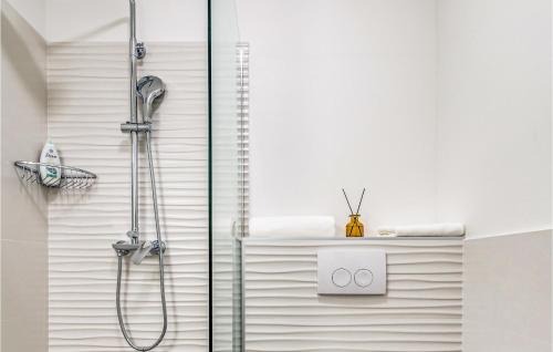 a shower in a bathroom with white walls at Stunning Home In Plano in Plano
