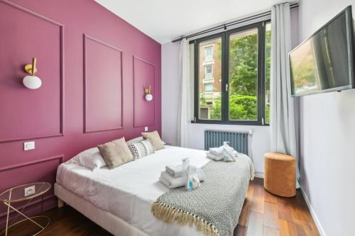 - une chambre avec des murs violets et un lit avec des animaux rembourrés dans l'établissement 197 Suite Tom - Superb Apartment in Paris, à Paris