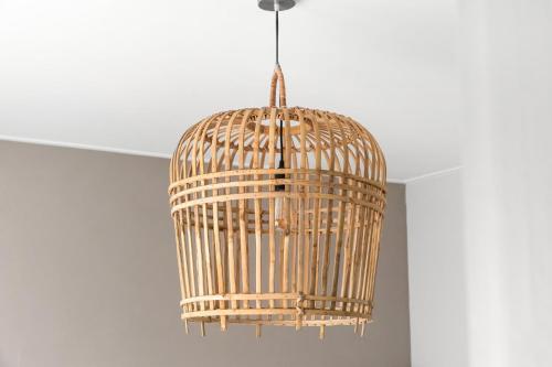 a wooden bird cage hanging from a ceiling at Bed & Bike De Dorsvloer in Domburg