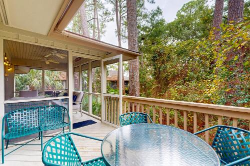 a patio with a table and chairs on a porch at Inlet Cove 11 in Kiawah Island