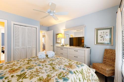 a bedroom with a bed and a flat screen tv at Inlet Cove 11 in Kiawah Island
