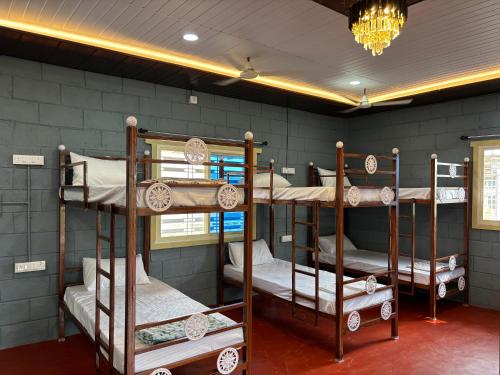 a room with four bunk beds in it at Mowgli's Cafe Hampi & Guest House in Hampi