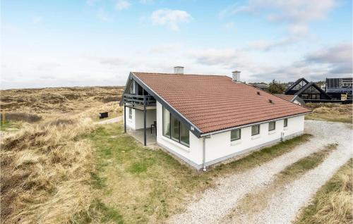 a white house with a brown roof on a field at Gorgeous Home In Thisted With Sauna in Thisted