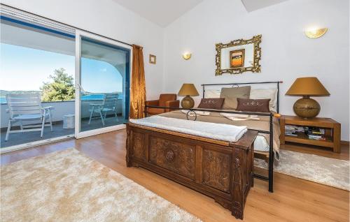 a bedroom with a bed and a large window at Three-Bedroom Holiday Home In Zaboric in Zaboric
