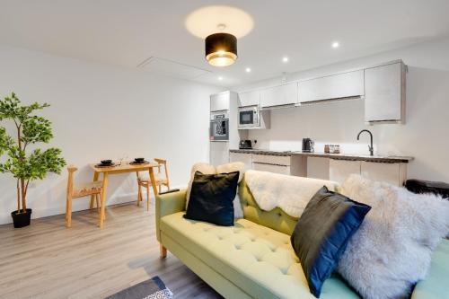 a living room with a couch and a kitchen at No 3 at The Rocketroom Apartments in Berwick-Upon-Tweed
