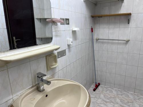 a bathroom with a sink and a mirror at Queen Cleopatra suite in Ajman 