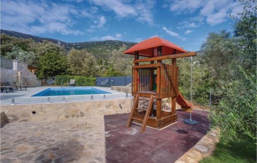 a wooden play tower next to a swimming pool at Pet Friendly Home In Sveti Jakov in Sveti Jakov