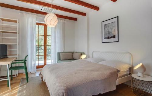 a white bedroom with a bed and a desk at Pet Friendly Home In Sveti Jakov in Sveti Jakov