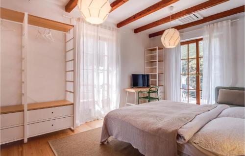 a bedroom with a bed and a tv and a window at Pet Friendly Home In Sveti Jakov in Sveti Jakov