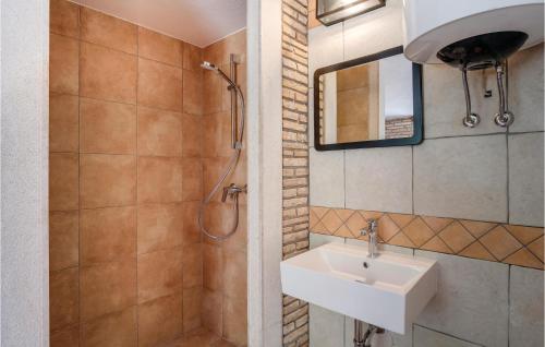a bathroom with a sink and a shower at Pet Friendly Home In Sveti Jakov in Sveti Jakov