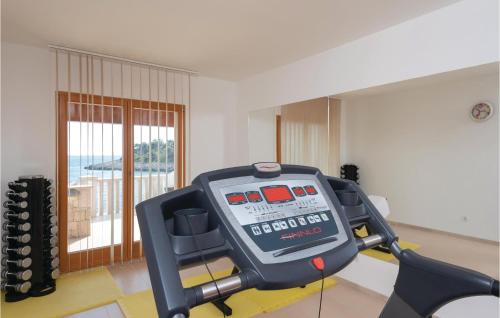 a gym with a scale in the middle of a room at Nice Home In Prizba With Sauna in Prizba
