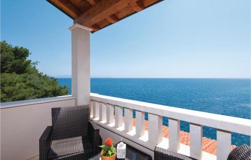 a balcony with chairs and a view of the ocean at Nice Home In Prizba With Sauna in Prizba