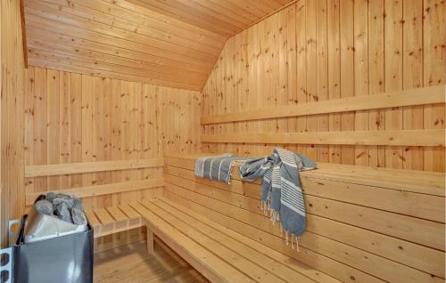 a wooden sauna with a towel on a rack at Gorgeous Home In Ulfborg With Wifi in Ulfborg