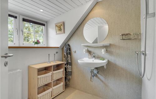 a bathroom with a sink and a mirror at Gorgeous Home In Ulfborg With Wifi in Ulfborg