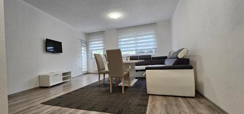 a living room with a couch and a table at Apartman Mima in Sanski most