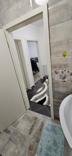 a bathroom with a toilet and a sink in a room at Apartman Mima in Sanski most