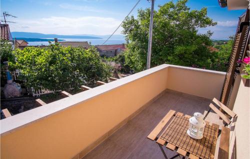 a balcony with a table and a bench on it at 2 Bedroom Amazing Home In Sveti Vid in Sveti Vid-Miholjice