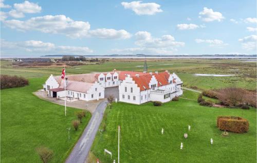an aerial view of a large white house with red roofs at Bakkegården in Arup
