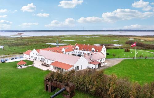 an aerial view of a large white house with red roofs at Bakkegården in Arup