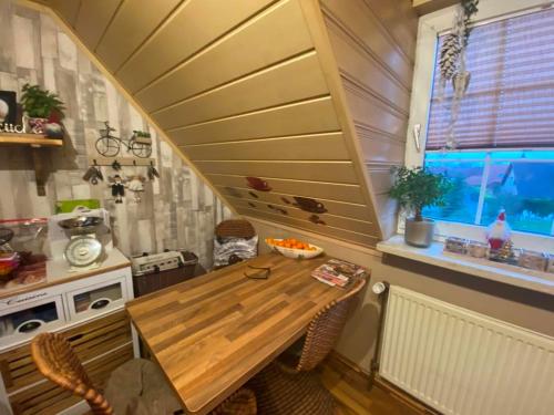 a kitchen with a wooden table and a window at lowbudget Unterkunft in Erwitte in Erwitte