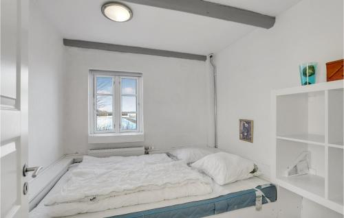 a bed in a white room with a window at Pet Friendly Home In Vils With Sauna in Vils