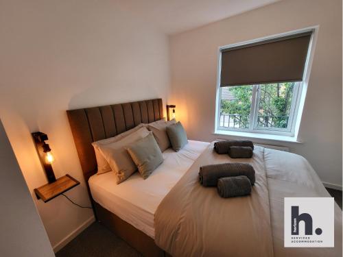 a bedroom with a large bed with a window at FREE Parking - Waterfront - Relocators - ST in Hull