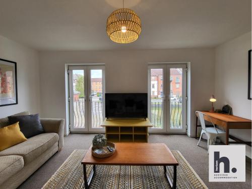 a living room with a couch and a tv at FREE Parking - Waterfront - Relocators - ST in Hull