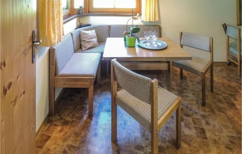 a dining room with a table and chairs and a couch at Ferienwohnung In Obernberg in Obernberg am Brenner