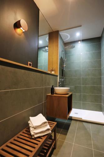a bathroom with a sink and a shower at La Grange de Colette in Le Tremblay-sur-Mauldre