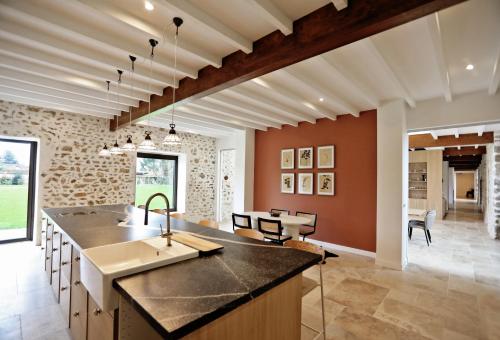 an open kitchen with a large island and a living room at La Grange de Colette in Le Tremblay-sur-Mauldre