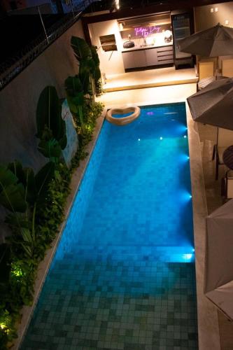 an overhead view of a swimming pool at night at Pipa Day Flats in Pipa
