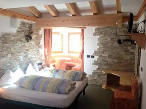 Postel nebo postele na pokoji v ubytování Hotel Ciamol