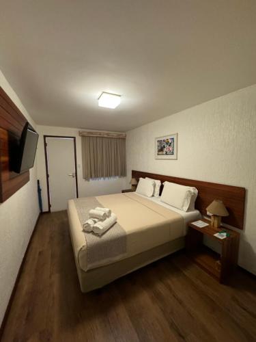 a hotel room with a bed and a television at Pousada da Germana in Fernando de Noronha
