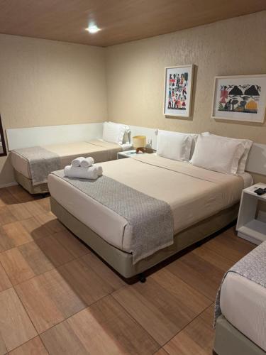 a hotel room with two beds in a room at Pousada da Germana in Fernando de Noronha